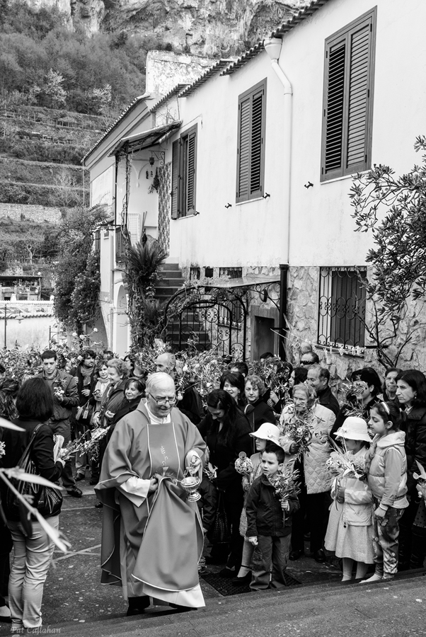 priest blesses the olive branches and chocolates during palm sunday in Monteperatuso